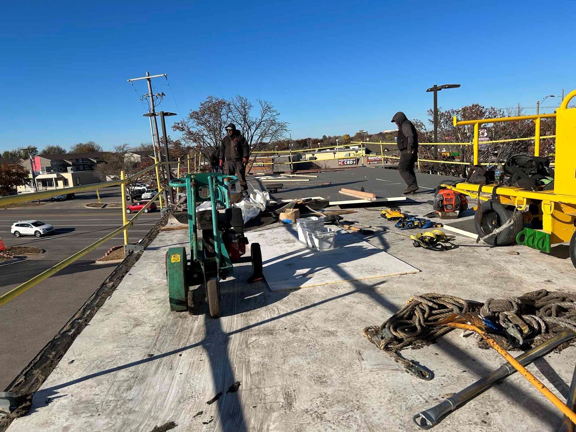 A group of construction workers are working on a roof.