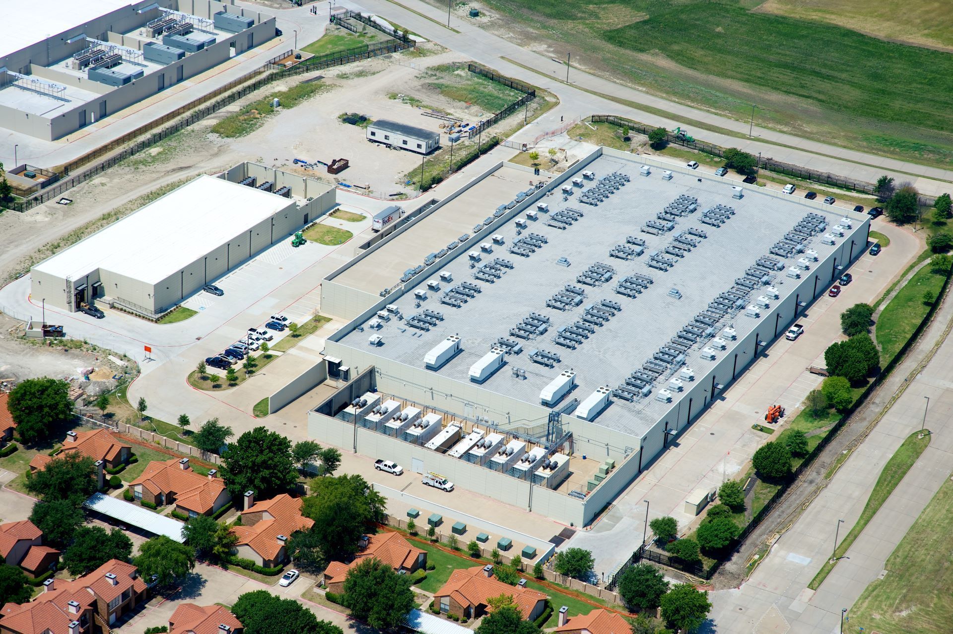 An aerial view of a large parking lot with lots of cars parked in it