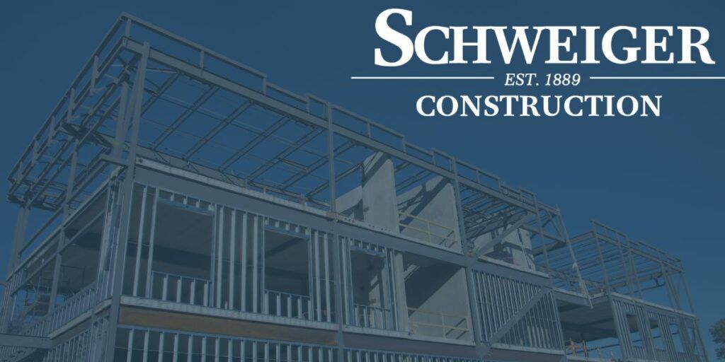 A picture of a building under construction that says ' schweiger construction ' on it