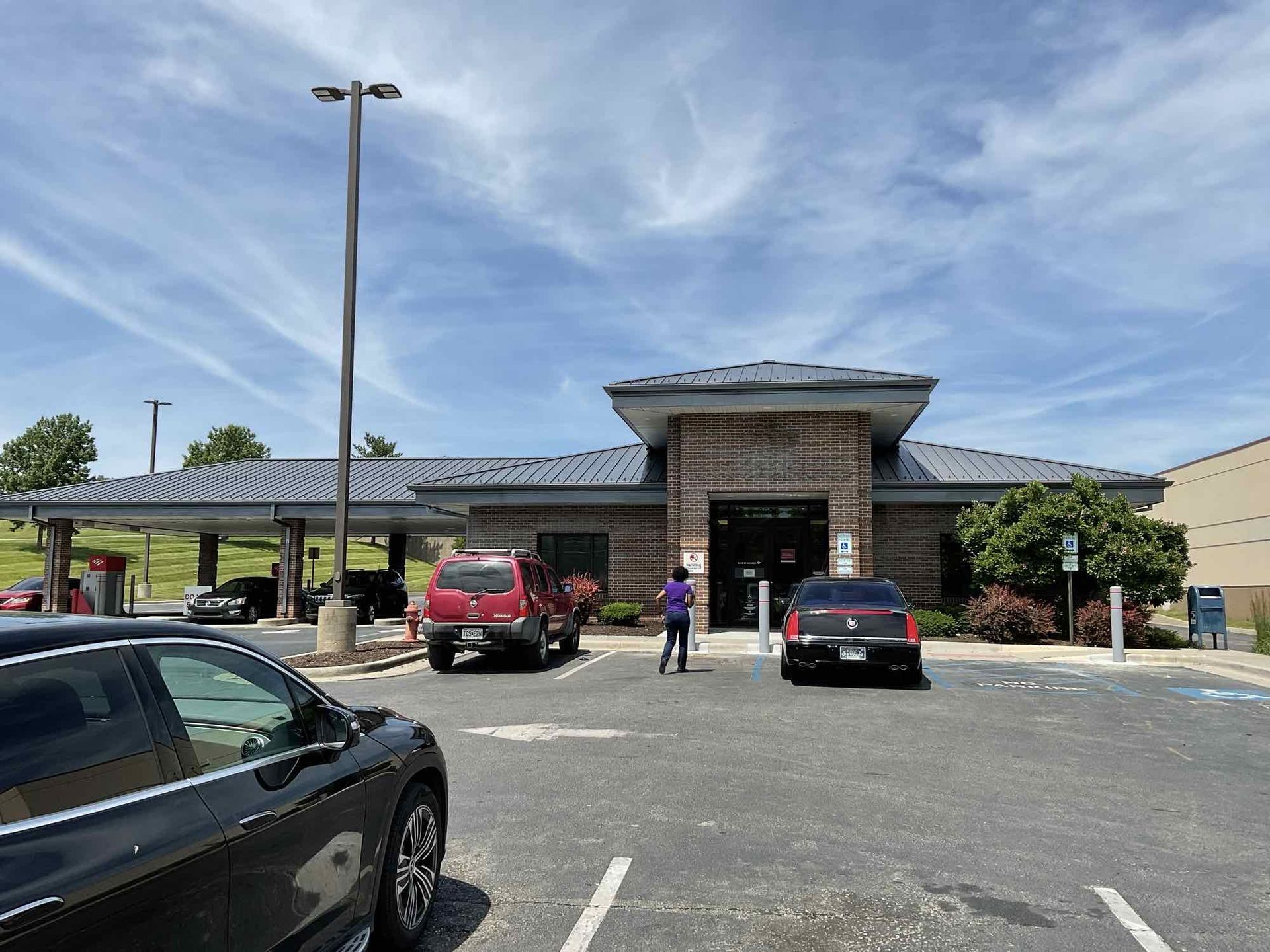 A bank of america building with a parking lot in front of it