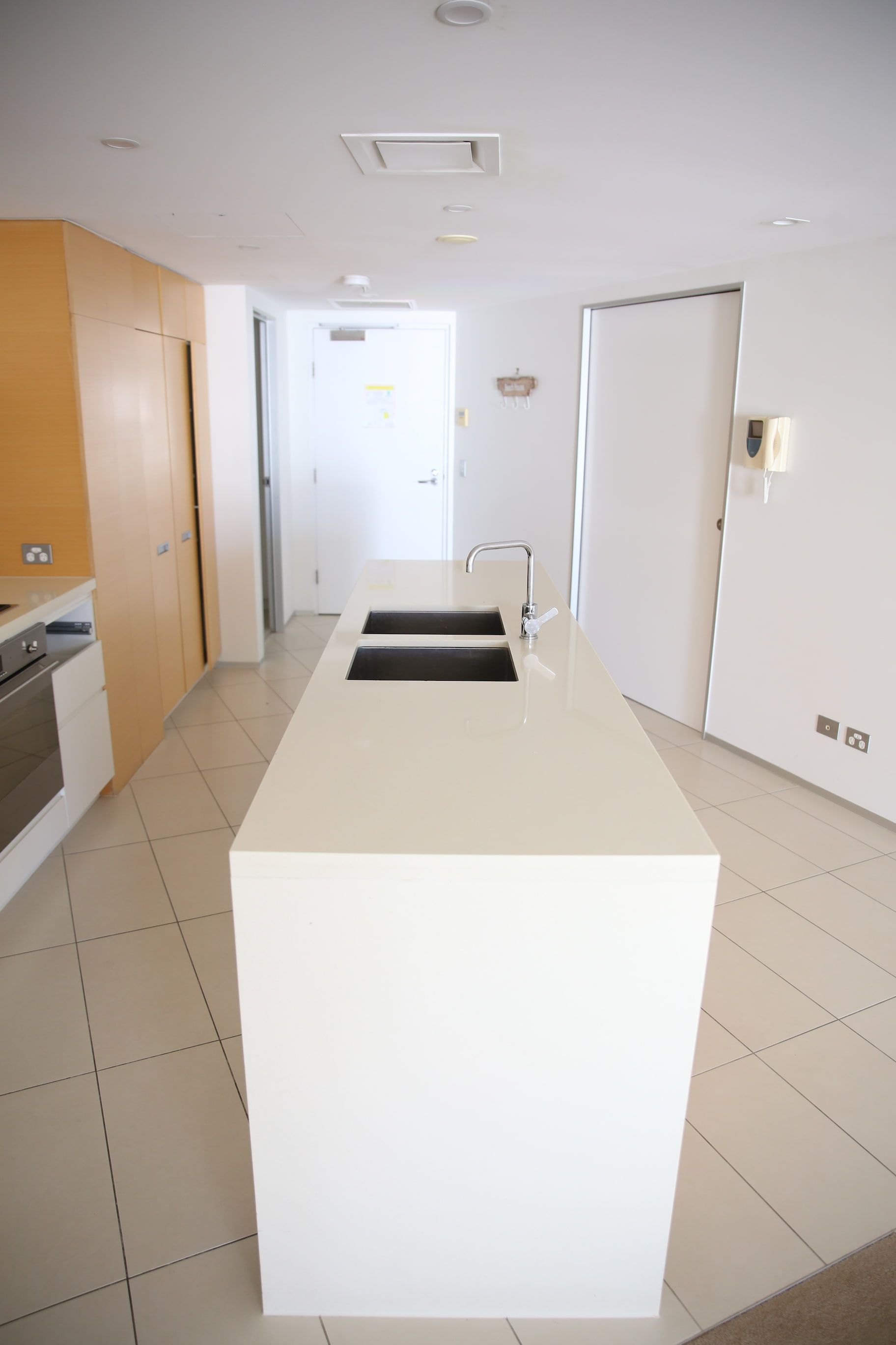 A kitchen with a large island and two sinks