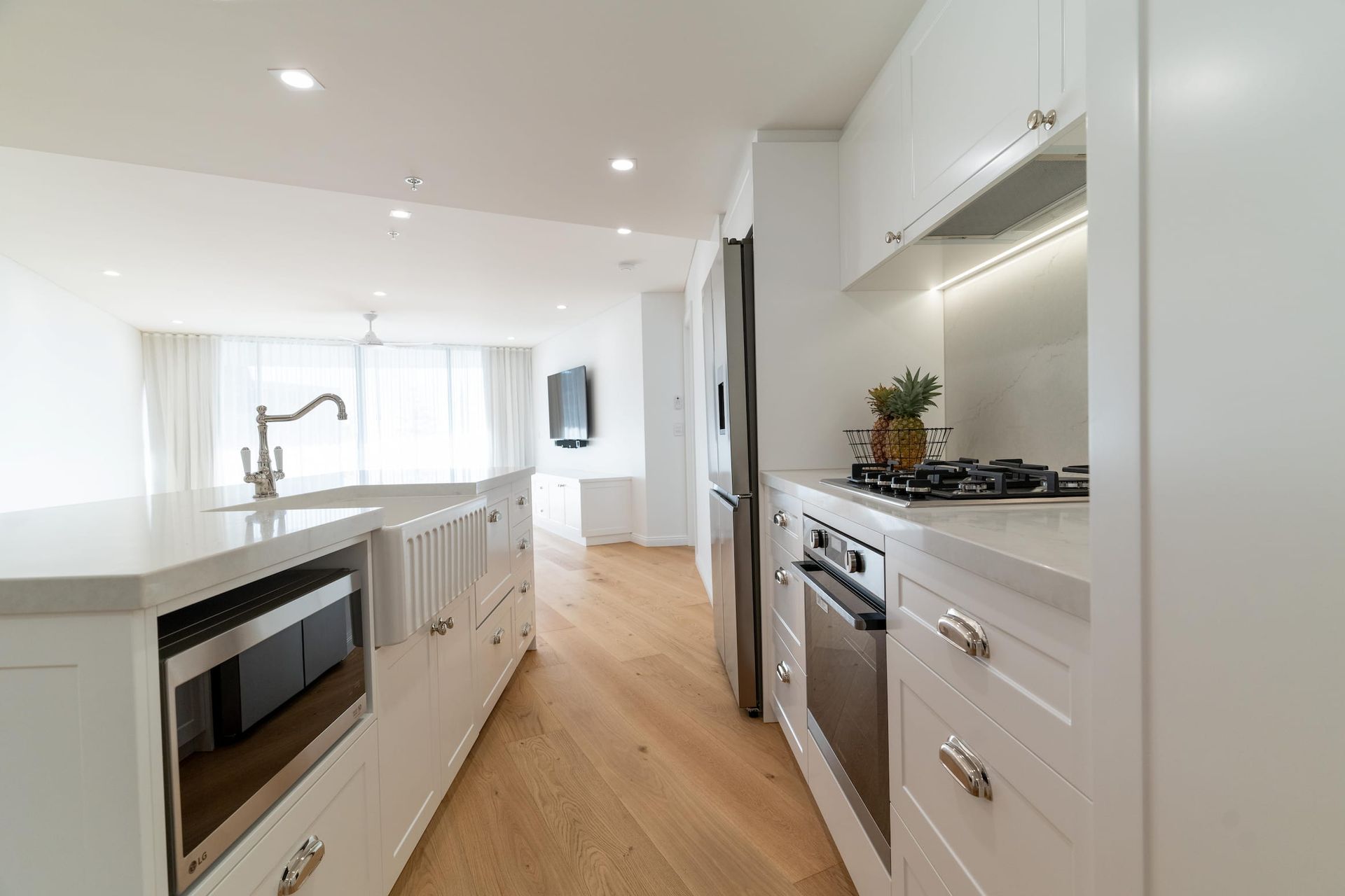 A kitchen with white cabinets and stainless steel appliances.