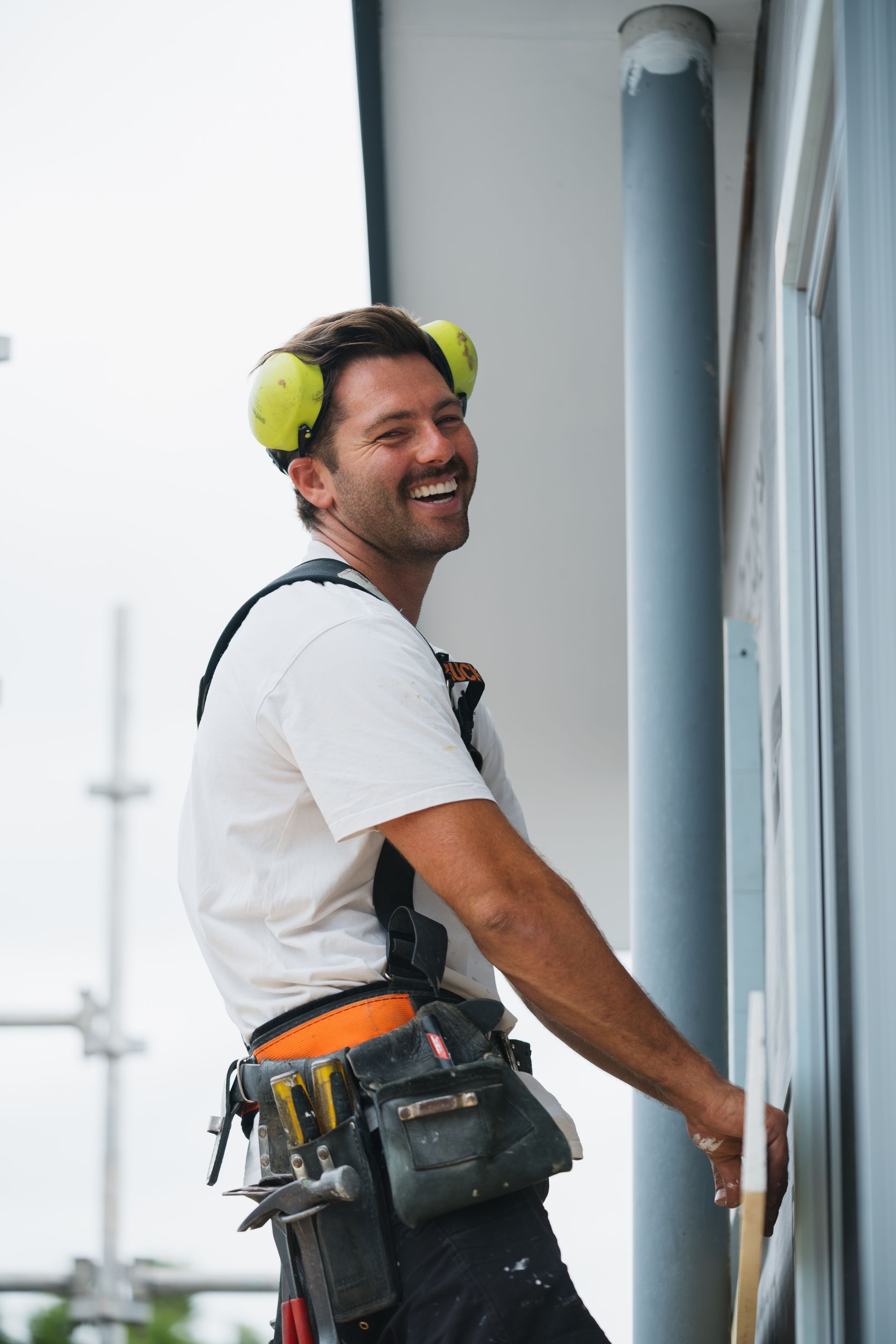 A man is using a circular saw to cut a piece of wood