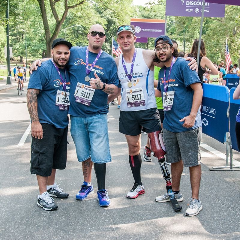 A group of men are posing for a picture with one wearing a shirt that says ' i 503 ' on it