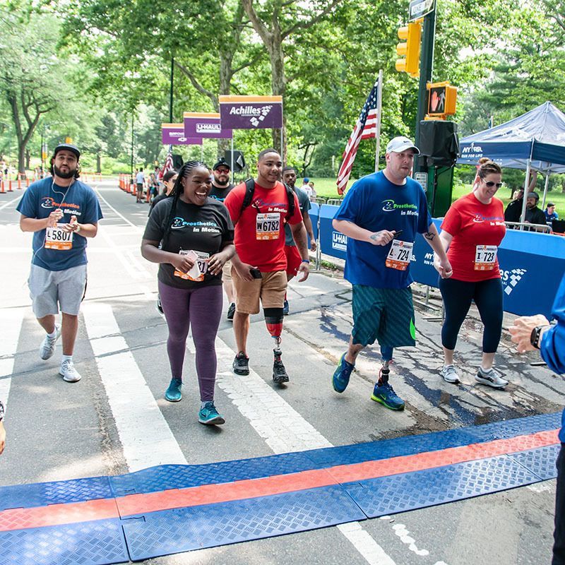 A group of people are walking across a street.