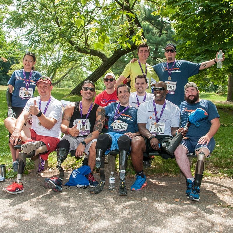 A group of people with prosthetic legs are posing for a picture
