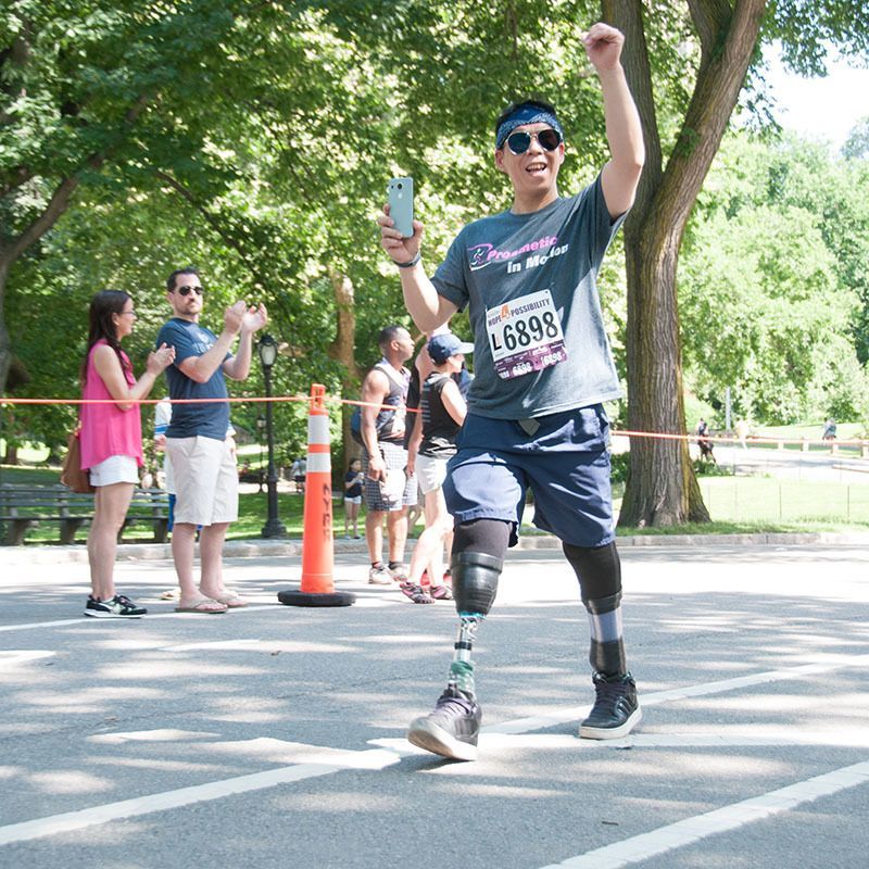 A man with a prosthetic leg has the number 46698 on his shirt