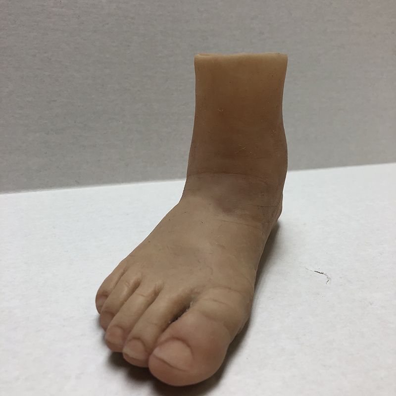 A fake foot is sitting on a white surface