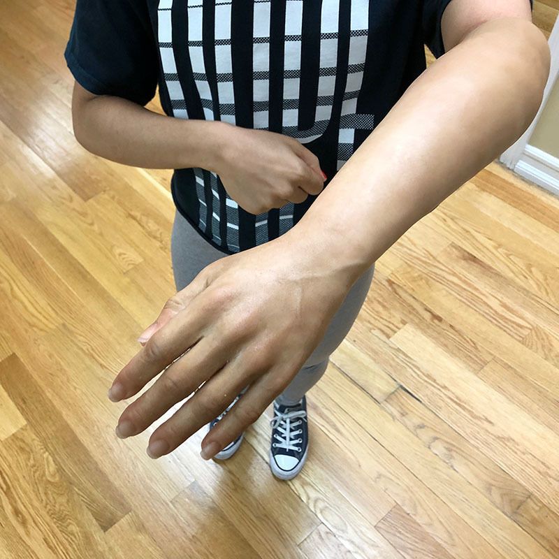 A person wearing a black shirt with white squares on it