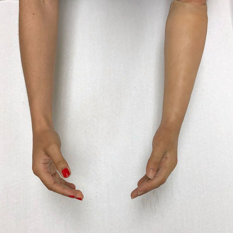 A woman 's hands with red nail polish on them