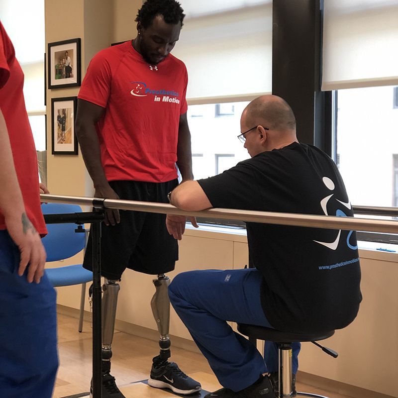A man with a prosthetic leg is talking to another man