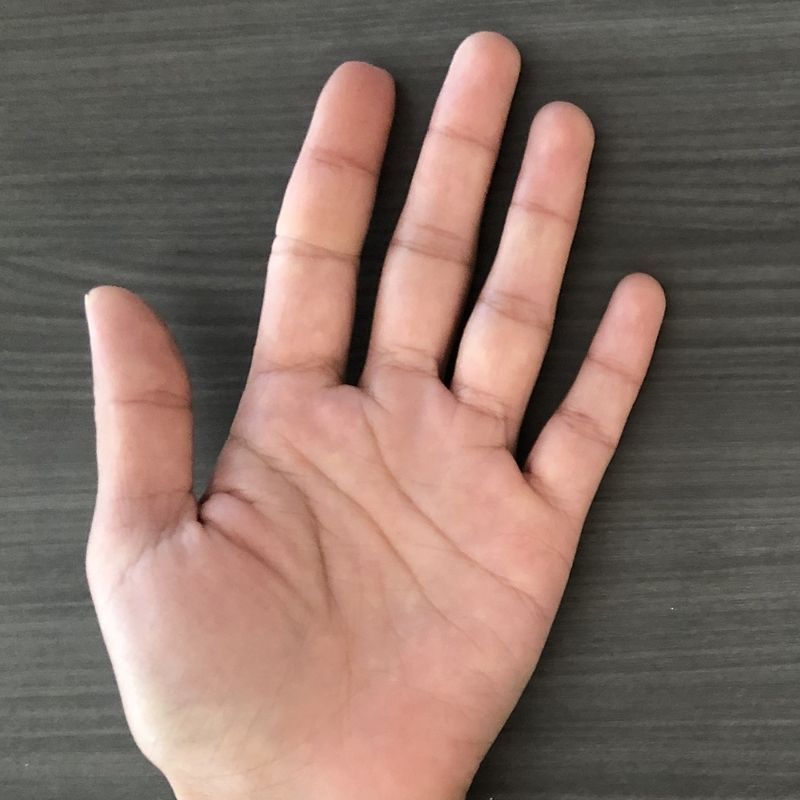 A close up of a person 's hand on a table
