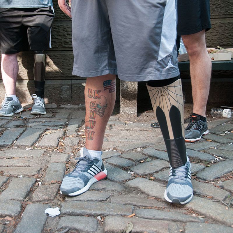 A man with a tattoo on his leg that says ' hurry '
