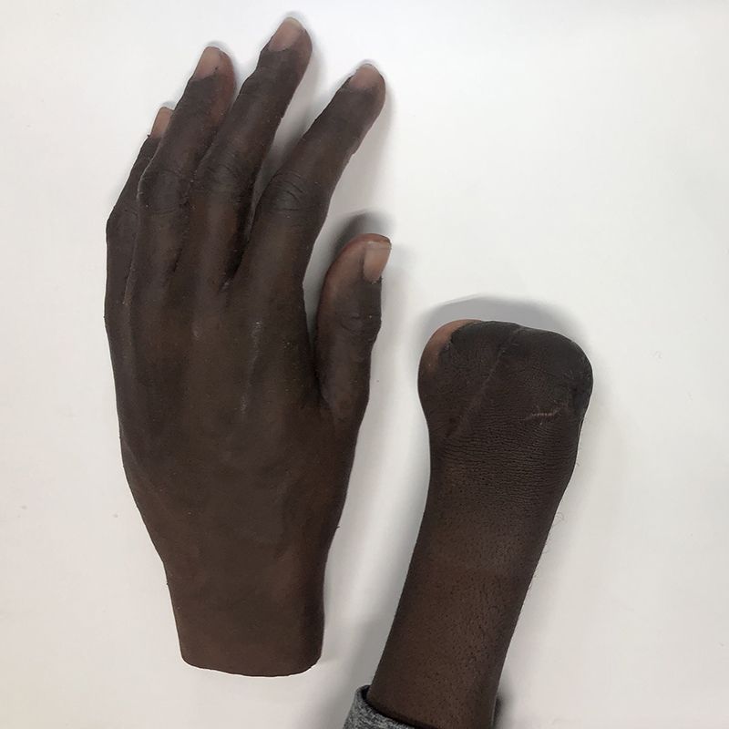 A person 's hands are shown on a white surface
