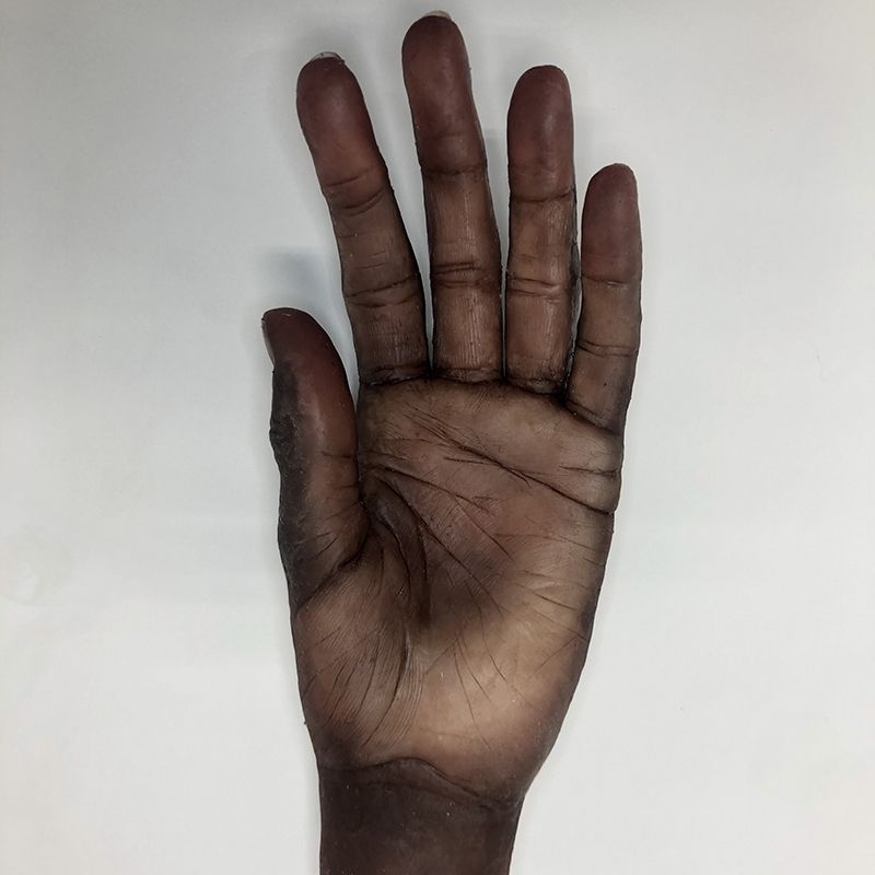 A close up of a person 's hand on a white surface