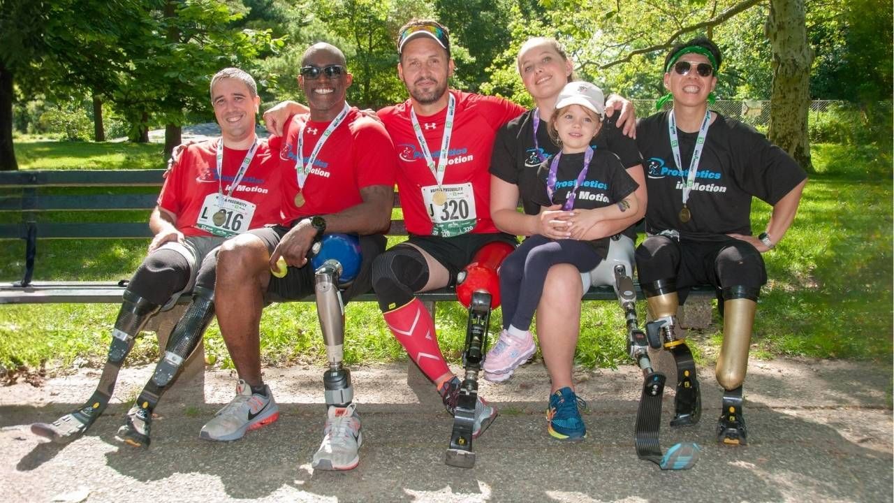A group of people with prosthetic legs are posing for a picture