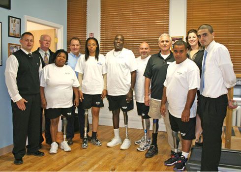 A group of people with prosthetic legs are posing for a picture
