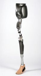A prosthetic leg is sitting on a white surface.