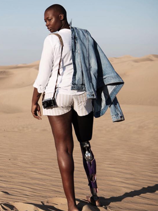 A woman with a prosthetic leg is walking in the desert