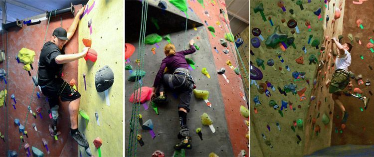 A man and a woman are climbing a climbing wall.