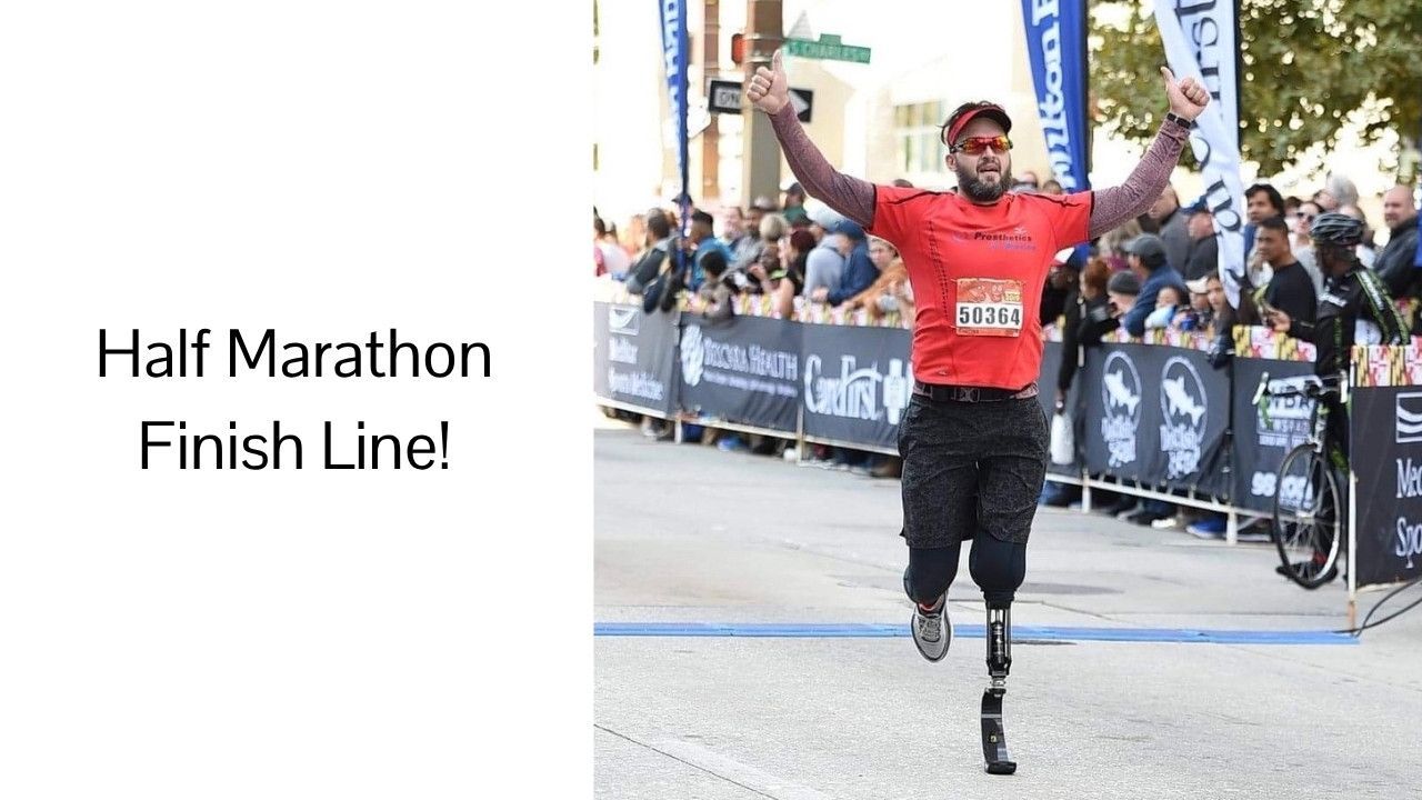 A man with a prosthetic leg crosses the half marathon finish line
