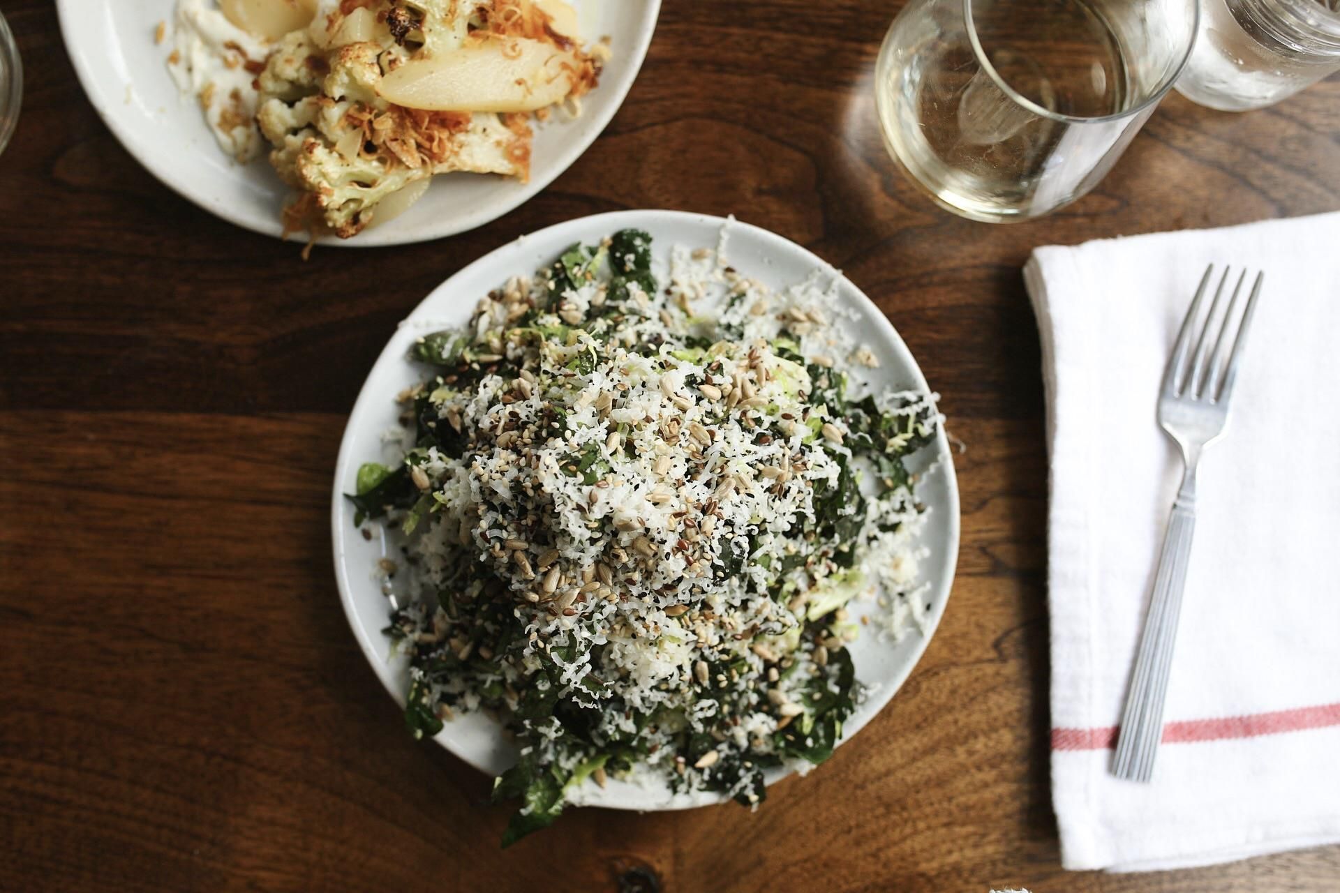 A plate of food with a fork on a wooden table
