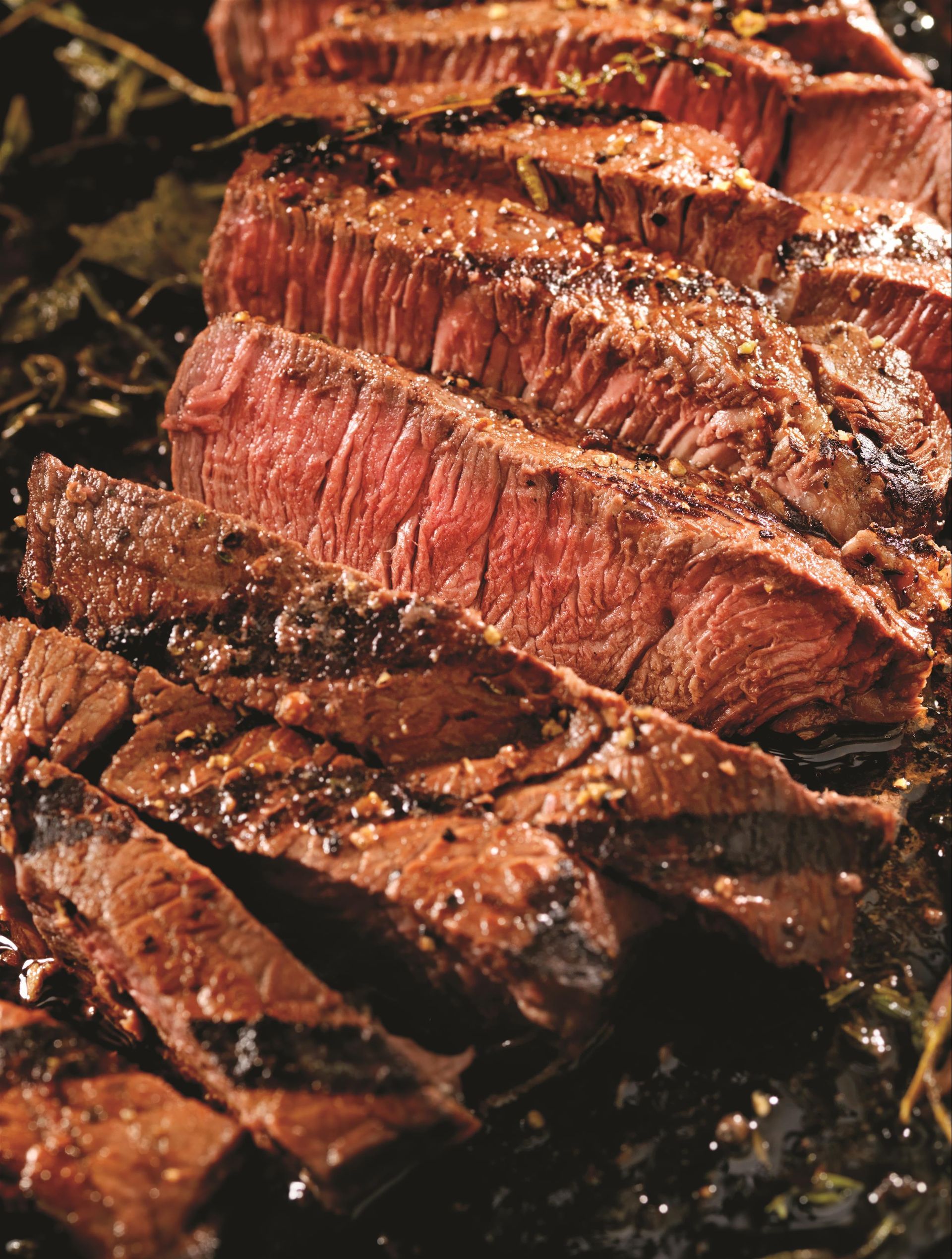A close up of sliced steak in a pan