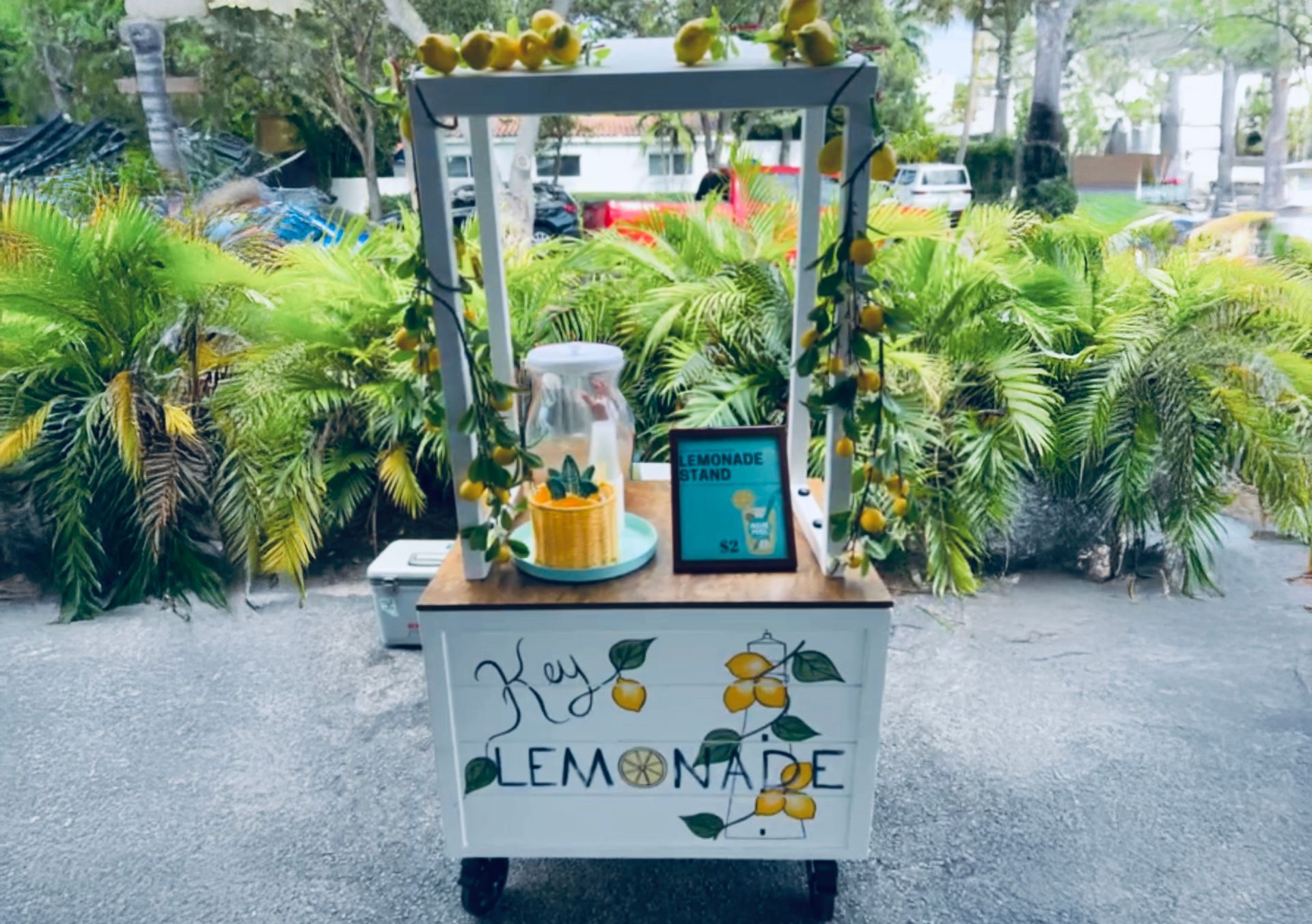 Lemonade stand with yellow lemonade and decorations.