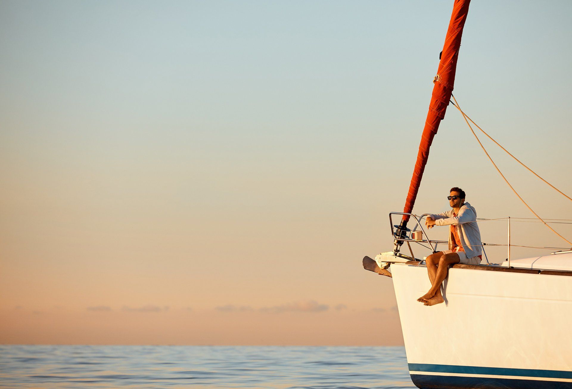 A man sitting on the edge of a boat
