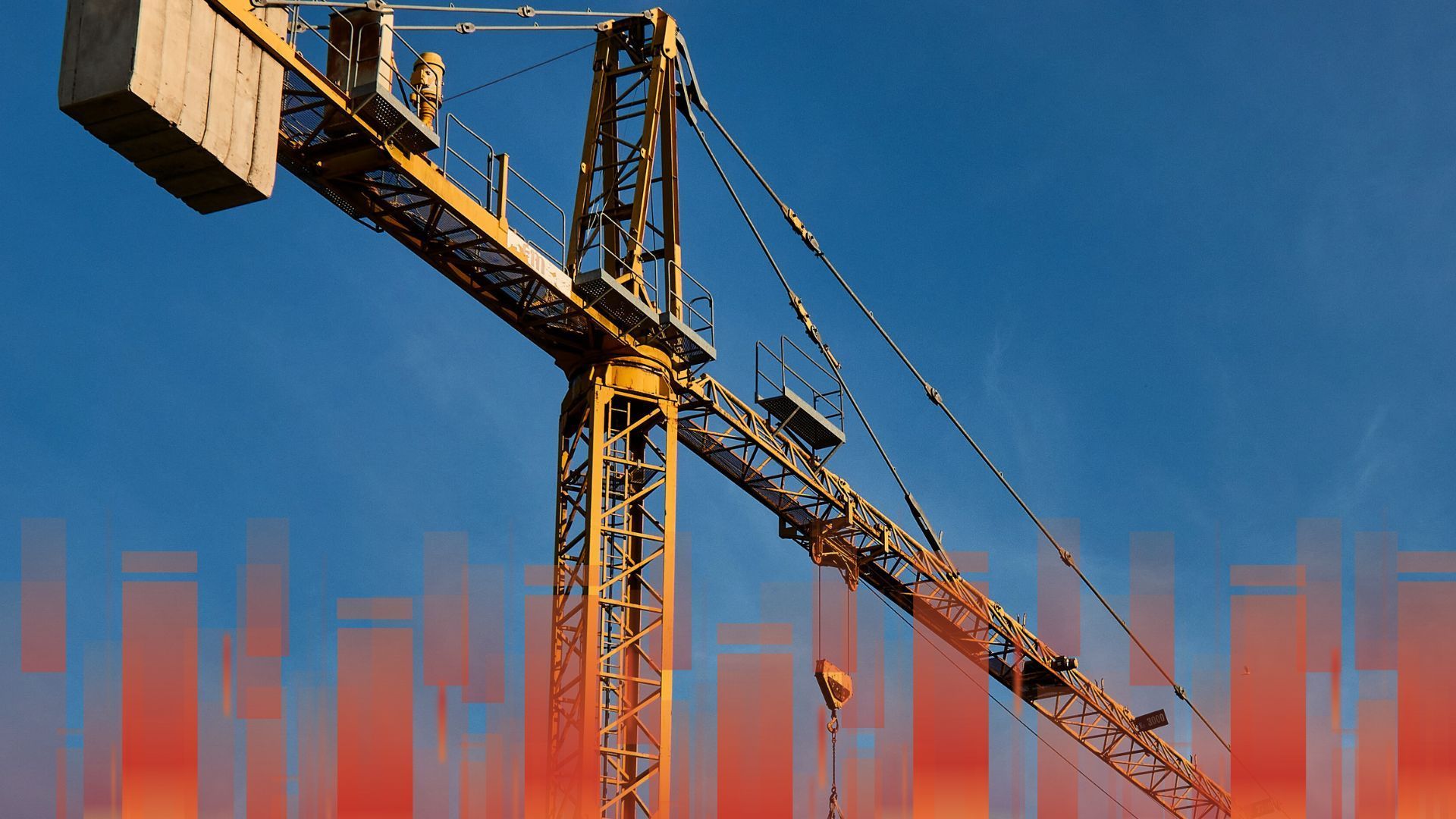 A yellow construction crane with a blue sky in the background