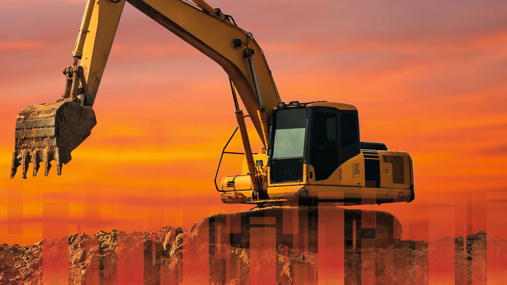 A yellow excavator is working on a construction site at sunset.