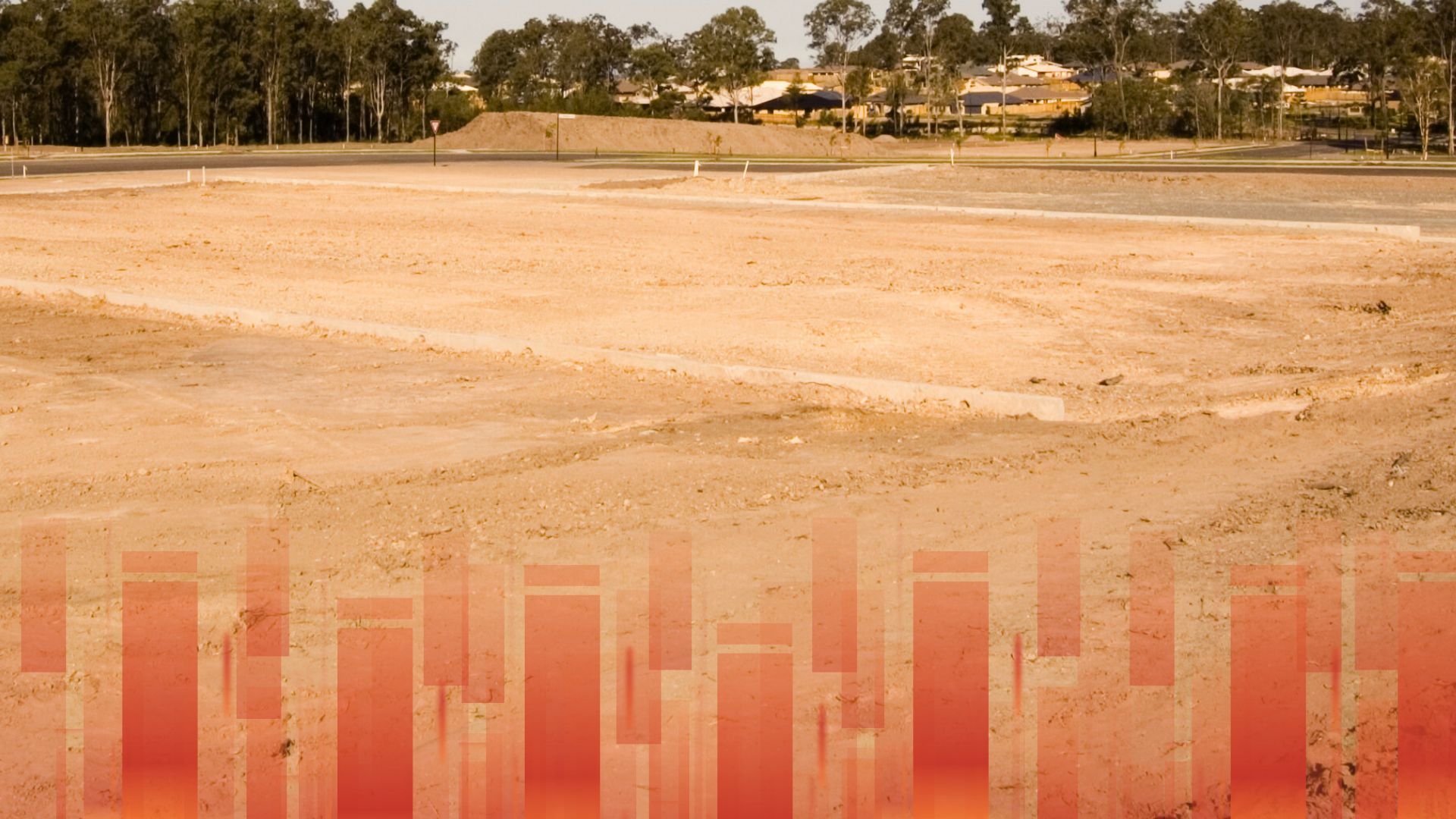 A picture of an empty field with trees in the background