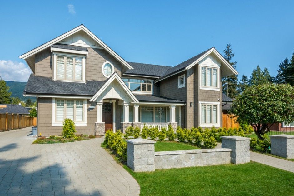 A Large House With a Lush Green Lawn and a Driveway in Front of It — Loan Select Tablelands in Atherton, QLD