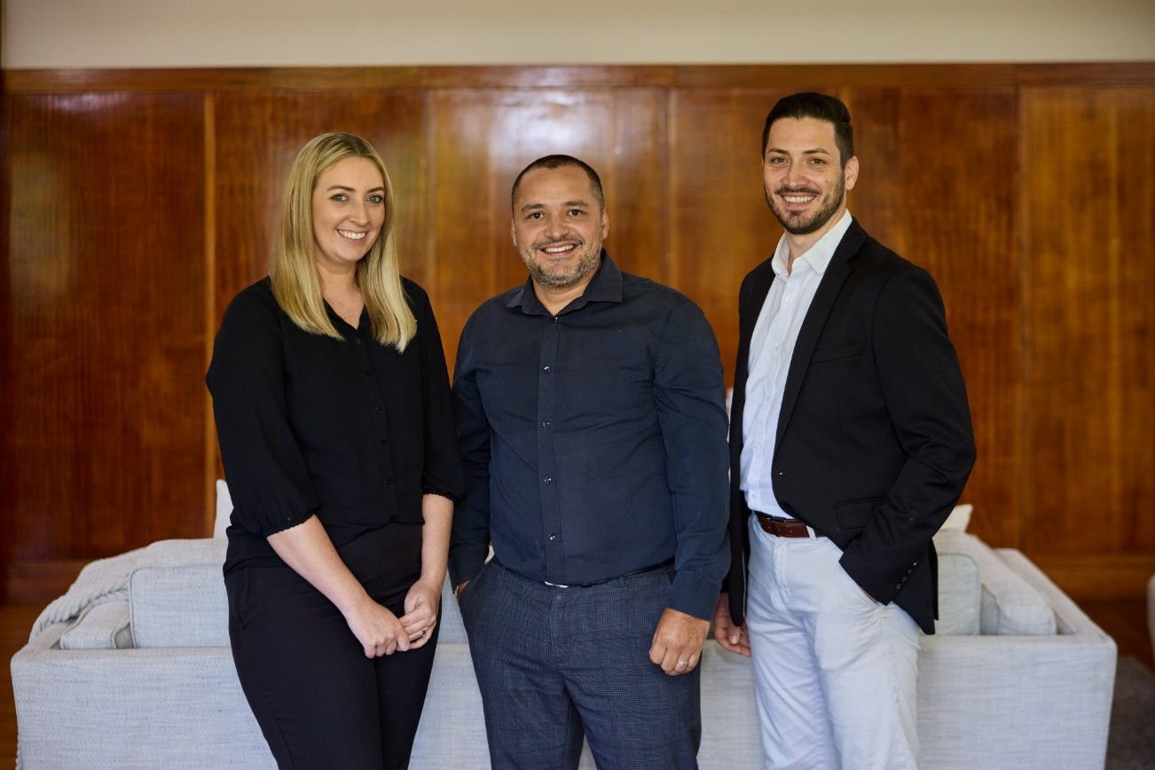 A Group of Three People Standing Next to Each Other in a Living Room — Loan Select Tablelands in Atherton, QLD