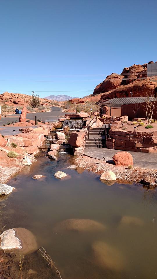 Red rock with river in the middle and steps to the side of the river