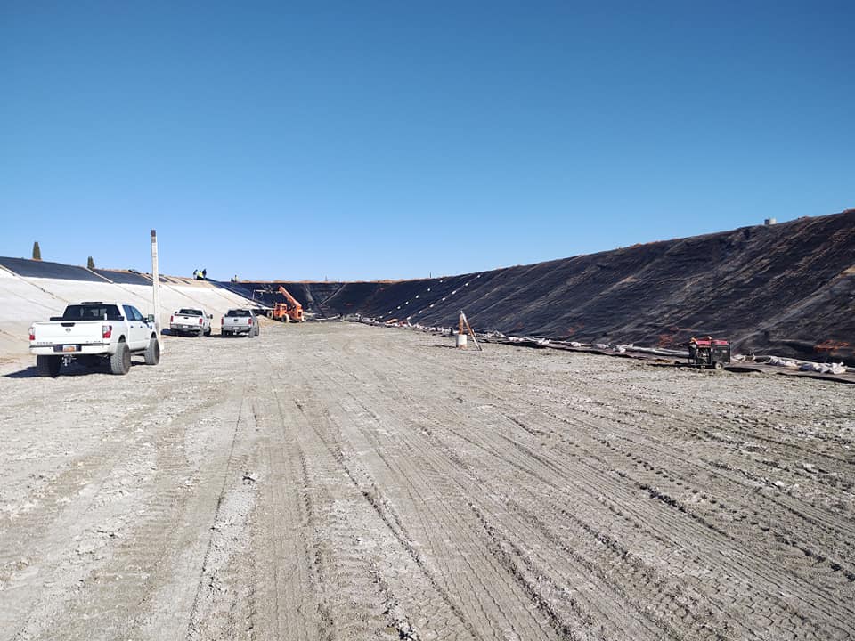 Large un-lined area being prepped by workers in the distance