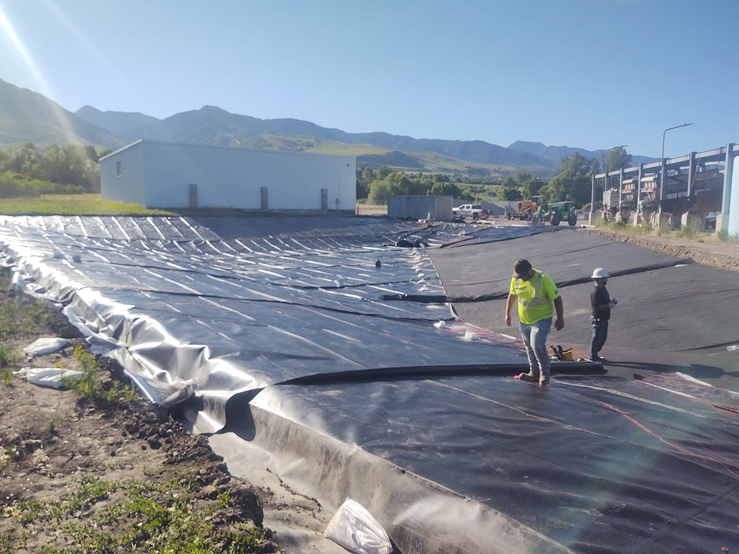 two workers walking on finished installed liner