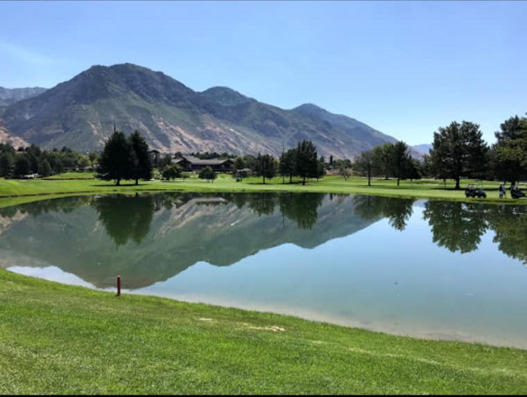 Pond with a reflection of a mountain in the distances