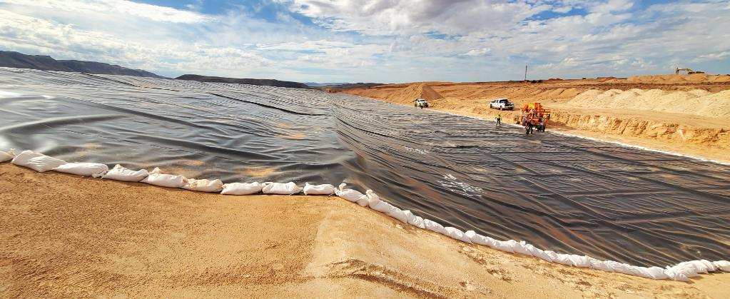 Liner on sand lined with sand bags