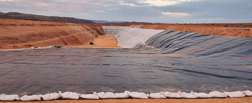 Liner being held down with sand bags during installation