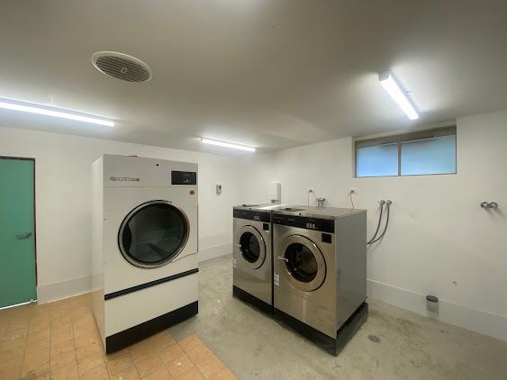 A Laundry Room with Two Washing Machines and A Dryer — Lakesway Plumbing and Gas in Forster, NSW