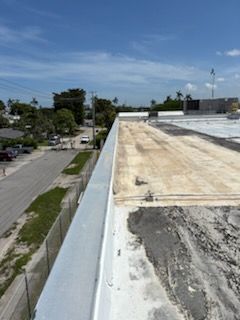 A roof with a gutter on it and a fence around it.