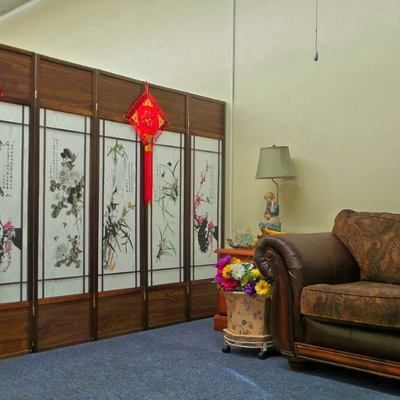 A living room with a couch and a lamp