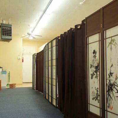 A hallway with brown curtains and a ceiling fan
