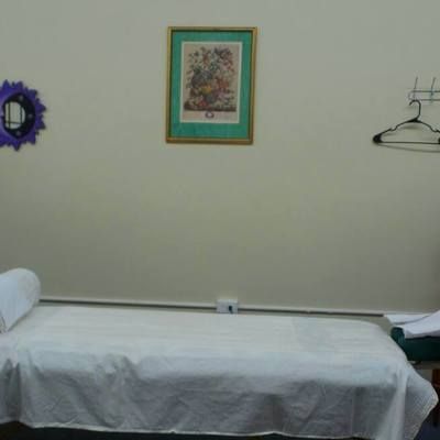 There is a picture on the wall above the bed.