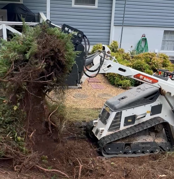 A small bulldozer is parked in front of a house.