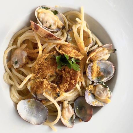 Una pentola piena di frutti di mare e verdure su un tavolo.