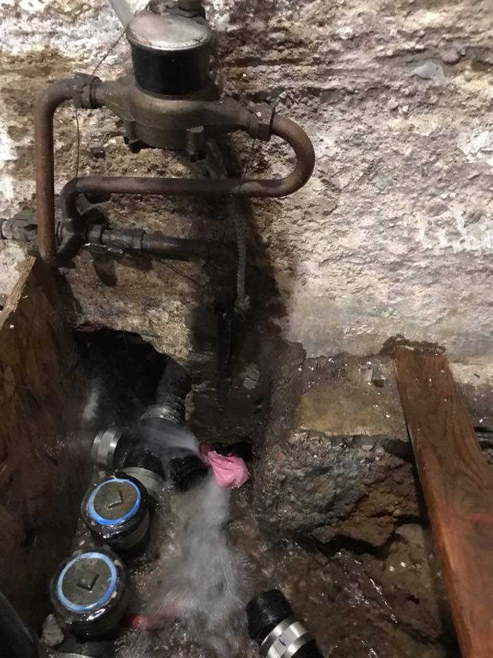 A close up of a water meter with water coming out of it.