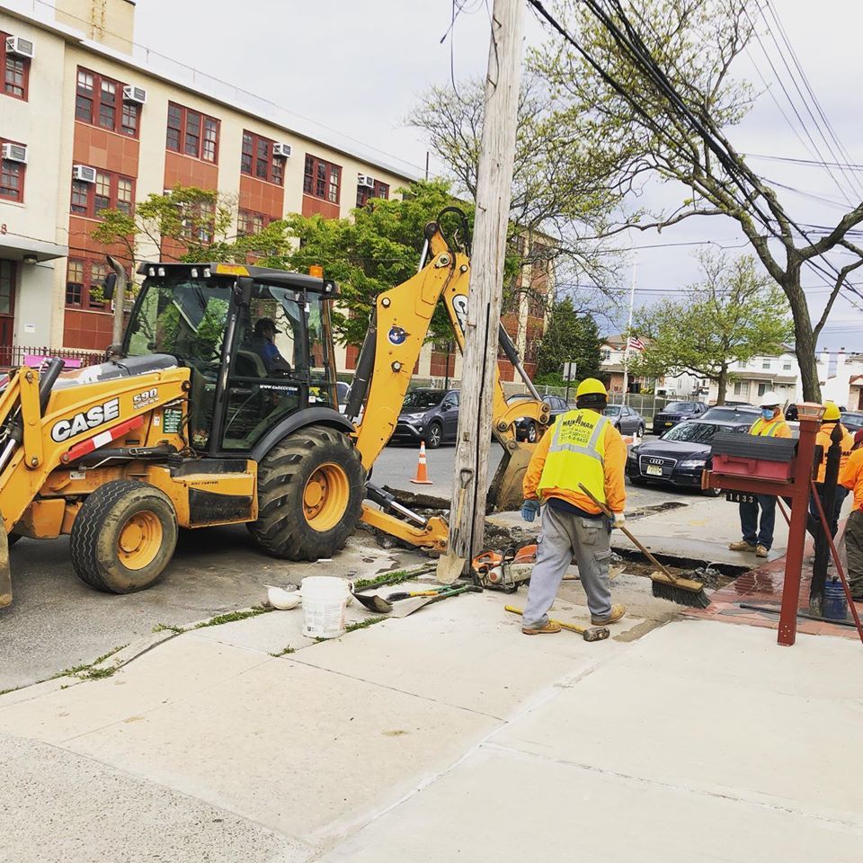 A yellow case tractor is parked on the side of the road