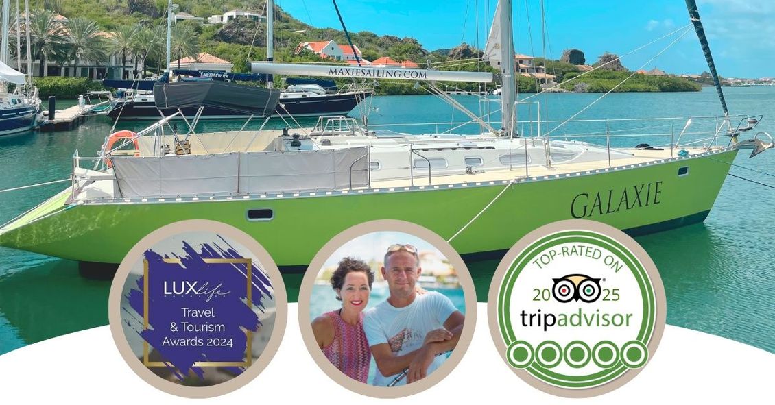 top-rated tours on Tripadvisor green sailboat Galaxie is docked in the harbour in Curacao